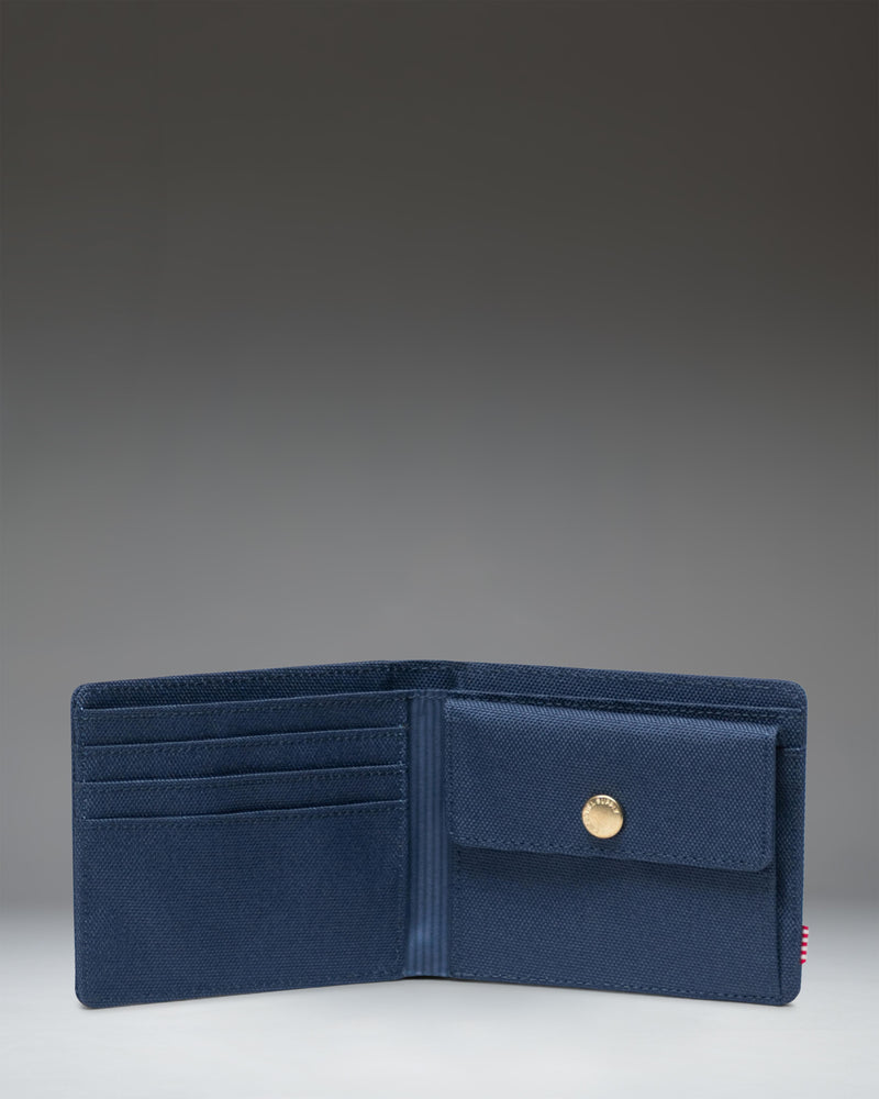 Herschel Supply Co Roy Coin Wallet in navy blue, shown opened flat to display the internal coin pocket and card slots.