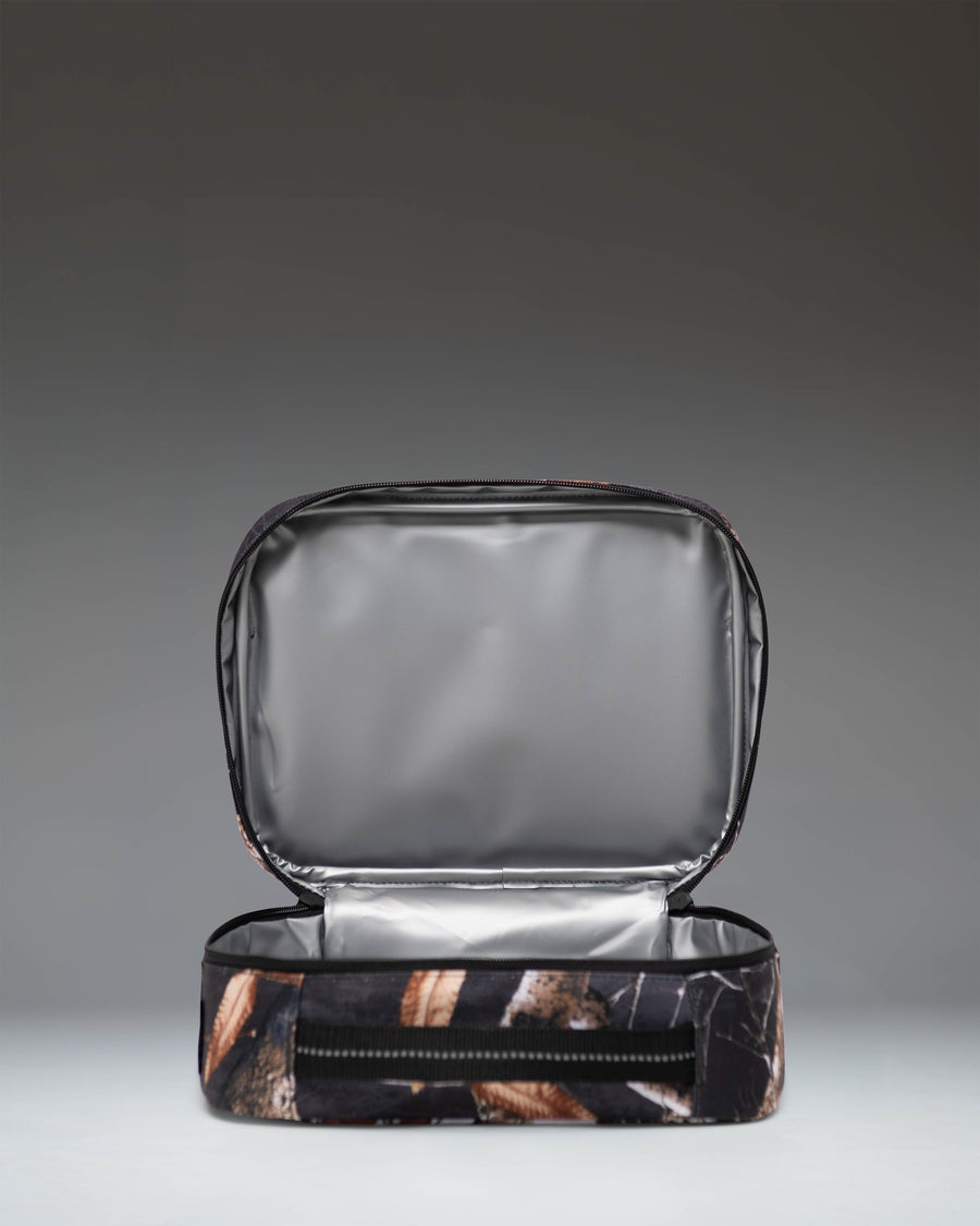 Herschel Supply Co. Realtree Pop Quiz Lunch Box in Realtree Edge Camo White/Black, showing an open main compartment view.