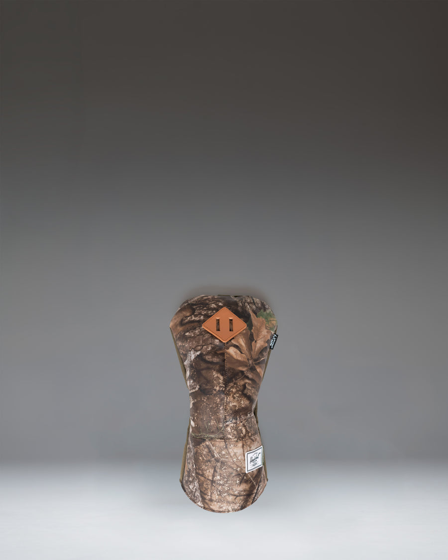 Herschel Heritage Driver Head Cover in Realtree APX Camo pattern featuring a classic design with a diamond accent patch.