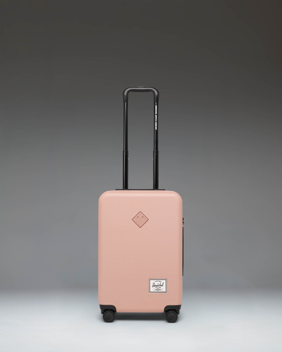 Herschel Heritage Hardshell Large CarryOn Luggage in Ash Rose pink.