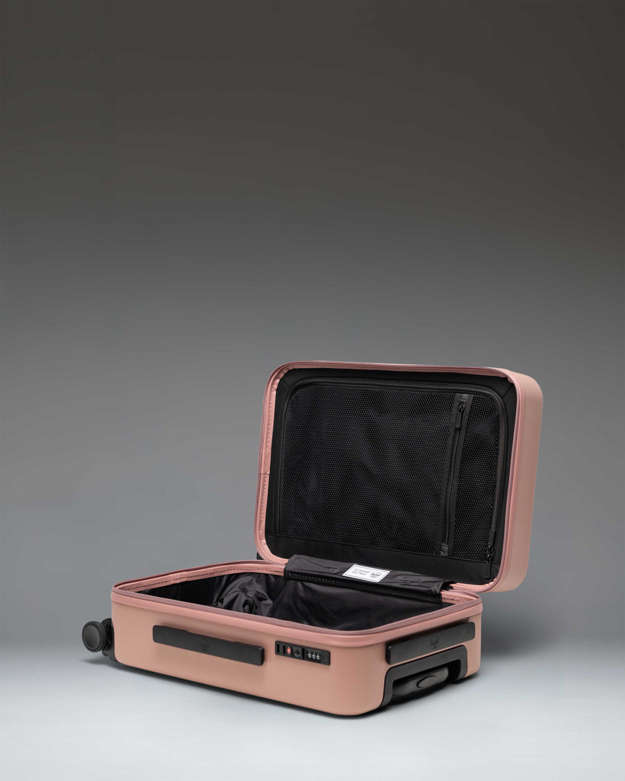 Herschel Heritage Hardshell Large Carry-On Luggage in Ash Rose showing a detailed close-up of the textured hard shell and zipper closure.