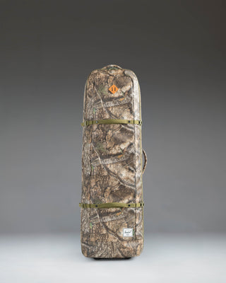 Herschel Heritage Golf Travel Wheelie Bag in Realtree APX Camo pattern, a rolling golf travel case with wheels and a top handle.