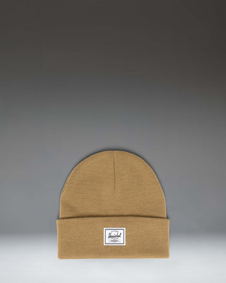 Herschel Supply Co. Elmer Beanie in Antique Bronze brown, showing the classic cuffed knit hat design with a white woven logo label on the front.
