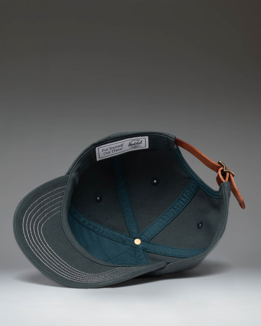 Herschel Sylas Premium Cap in Green Gables with vintage white contrast stitching, unstructured low crown, and curved brim.