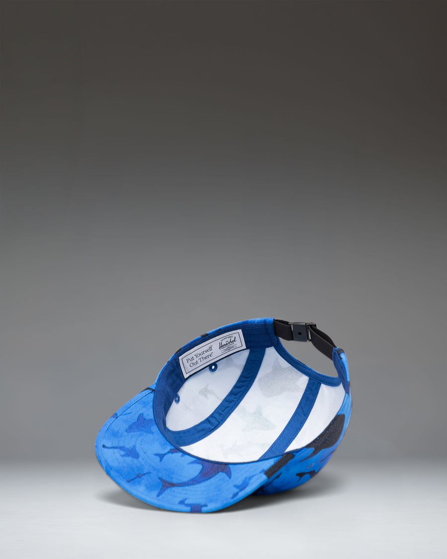 Herschel Supply Co. Glendale Kids Cap in Sharks print, featuring a blue background with various shark illustrations.