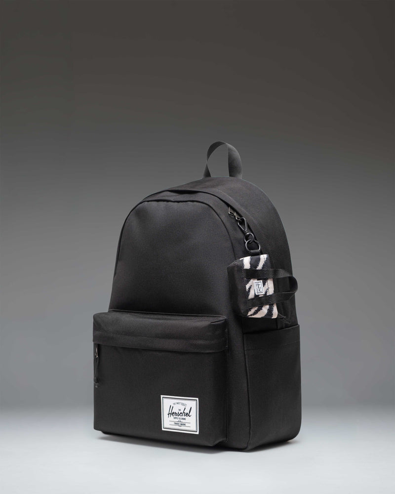 Herschel Heritage Tote Bag Charm in a striking black and white zebra print pattern.