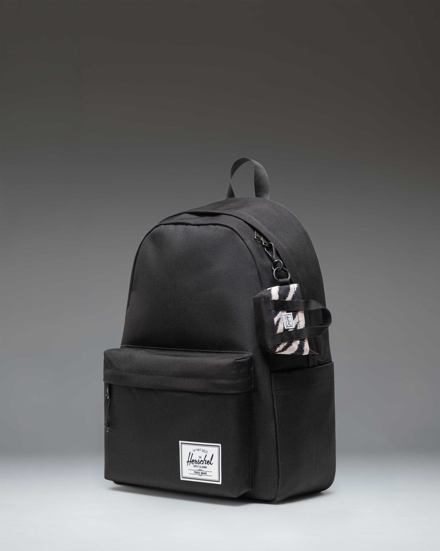 Herschel Heritage Tote Bag Charm in a striking black and white zebra print pattern.