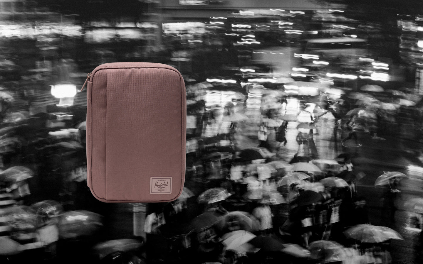 Herschel Supply Co. Burrard Organizer Tech in Ash Rose Tonal displayed flat on a desktop surface, showing its compact, zip-around design.