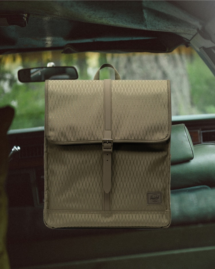 Herschel Supply Co. City Backpack in Ivy Green Diamond, shown from the front on a mobile device display.