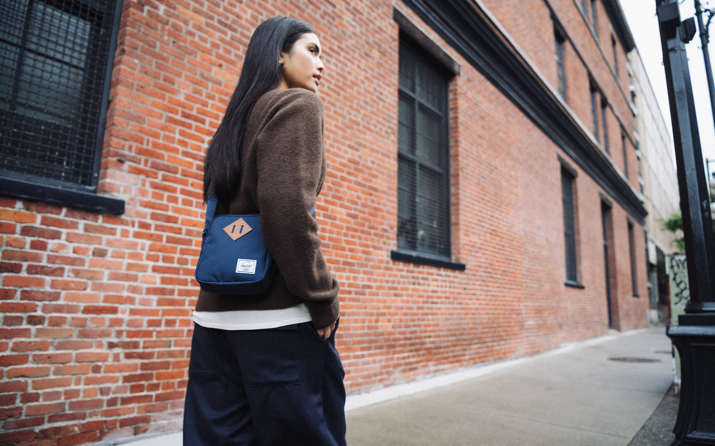Herschel Heritage Crossbody bag in navy blue shown from the front against a clean background, highlighting its classic design.