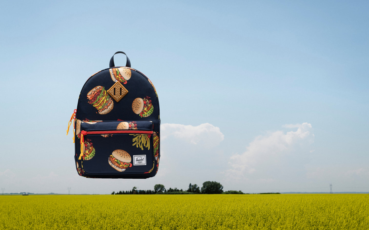 Herschel Heritage Kids Backpack in navy blue and pink, showcasing its classic design, front storage pocket, and durable shoulder straps.