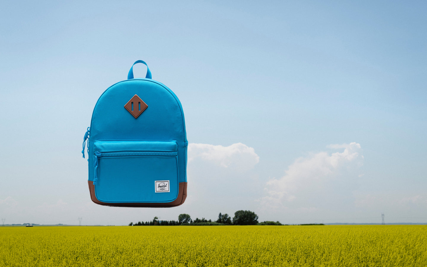 Herschel Heritage Kids Backpack in Hawaiian Surf blue with Saddle Brown accents, shown from the front on a plain background.