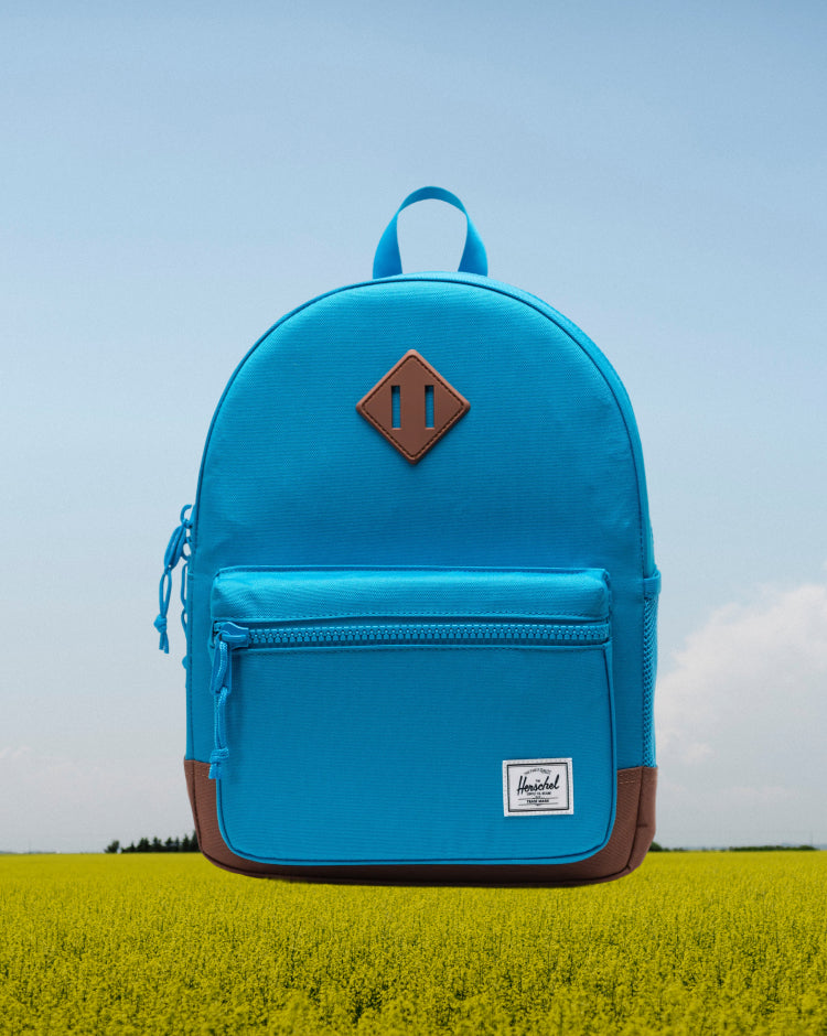 Herschel Heritage Kids Backpack in Hawaiian Surf blue with Saddle Brown details, shown from the front.
