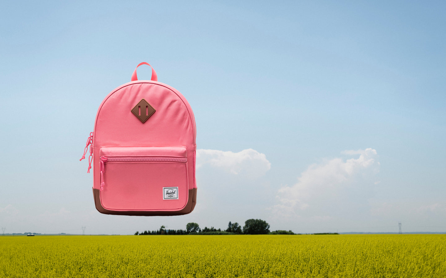 Herschel Heritage Kids Backpack in Confetti and Saddle Brown, featuring a colorful confetti pattern and a brown diamond accent.