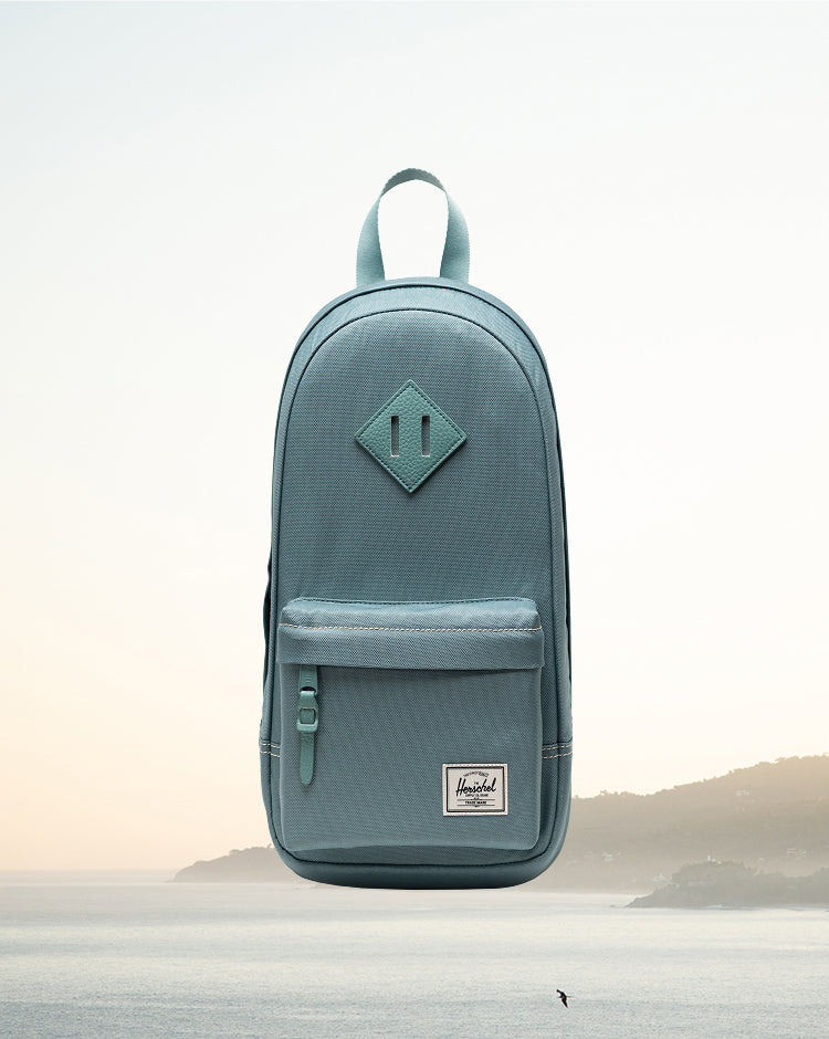 Herschel Heritage Shoulder Bag in Black Tonal being worn as a crossbody bag.
