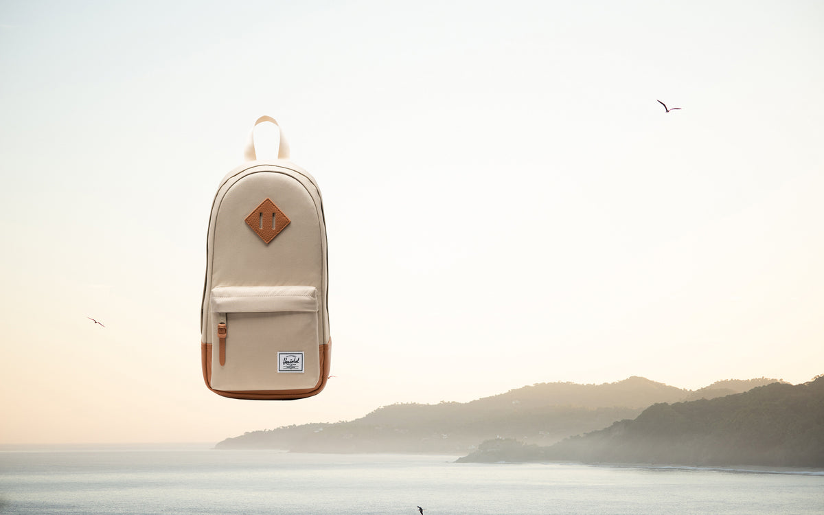 Herschel Supply Co. Heritage Shoulder Bag in Eucalyptus green, shown from a front lifestyle angle.