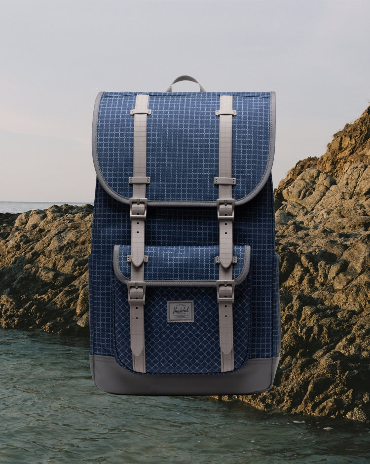 Herschel Little America Backpack in Grid Naval Academy/Magnet color, showing the front design with straps.