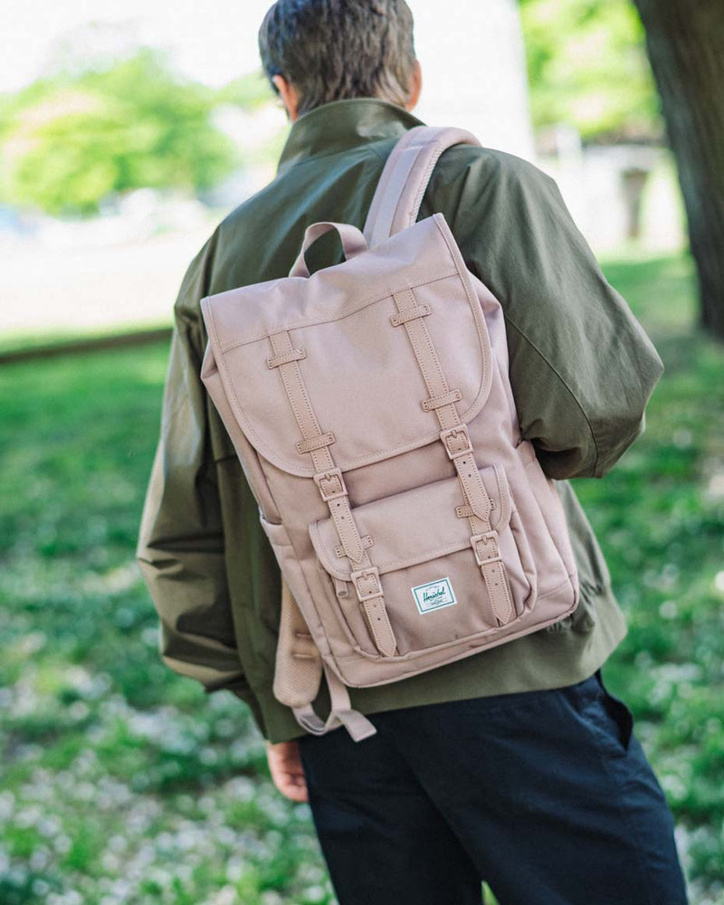 Herschel Supply Co. Herschel Little America Mid Backpack in Ash Rose pink, featuring a front pocket, dual straps, and a woven logo label.