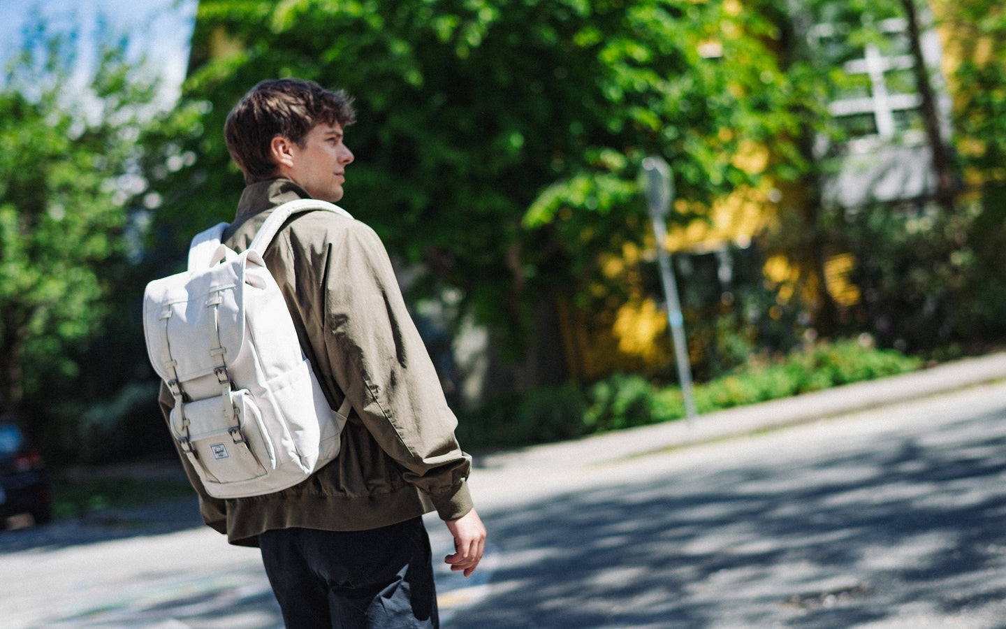 Herschel Little America Mid Backpack in Moonbeam beige color, showing the front design with dual brown rubber straps and a white logo label.