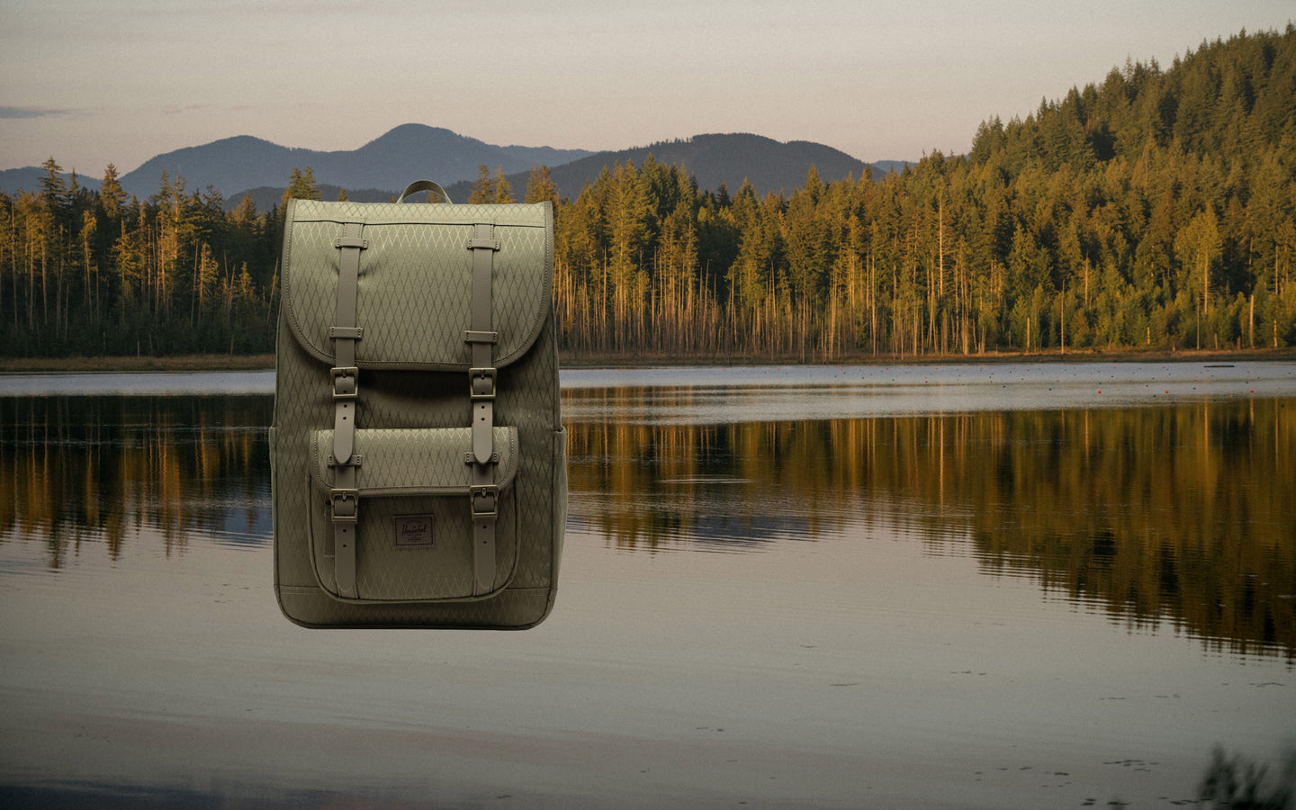 Herschel Little America Mid Backpack in Ivy Green Diamond, shown on a desktop banner.