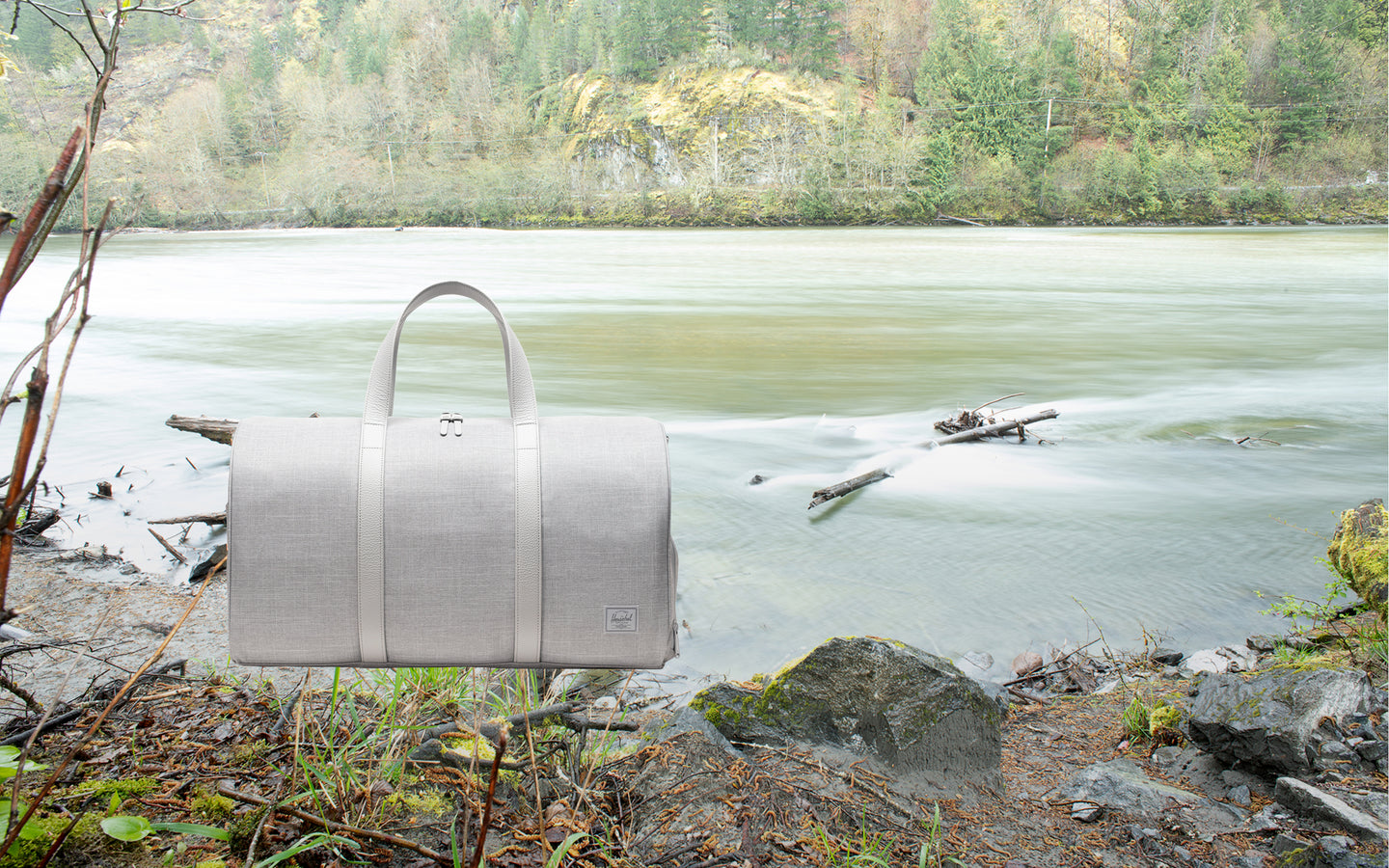 Herschel Supply Co. Novel Duffle bag in Grey Crosshatch, shown from the side against a white background.