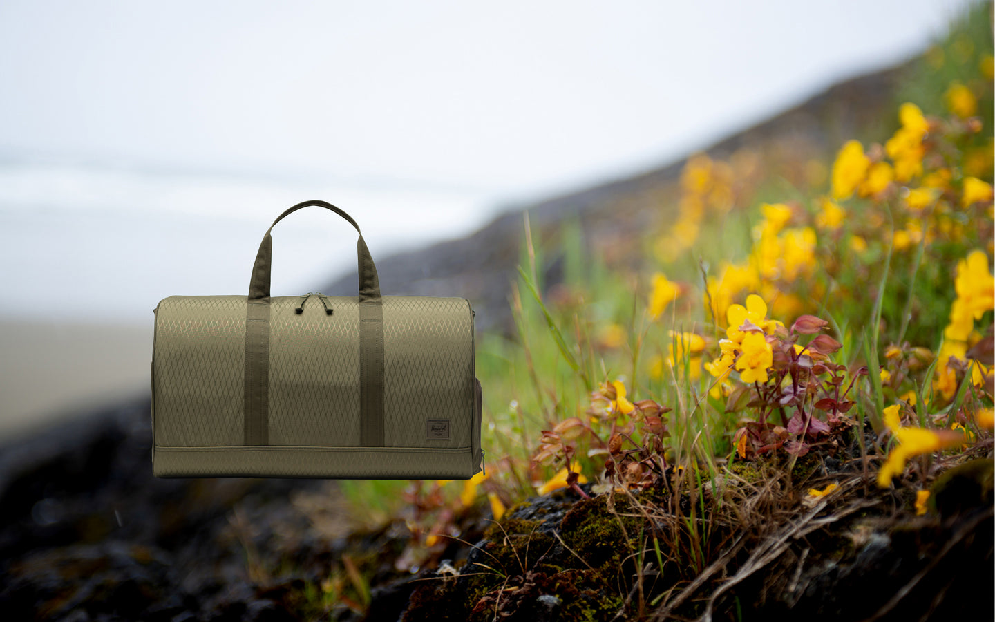 Herschel Novel Duffle bag in Ivy Green Diamond.