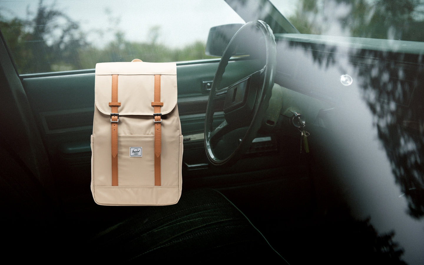 Herschel Retreat Backpack in Eucalyptus green on a desktop background.