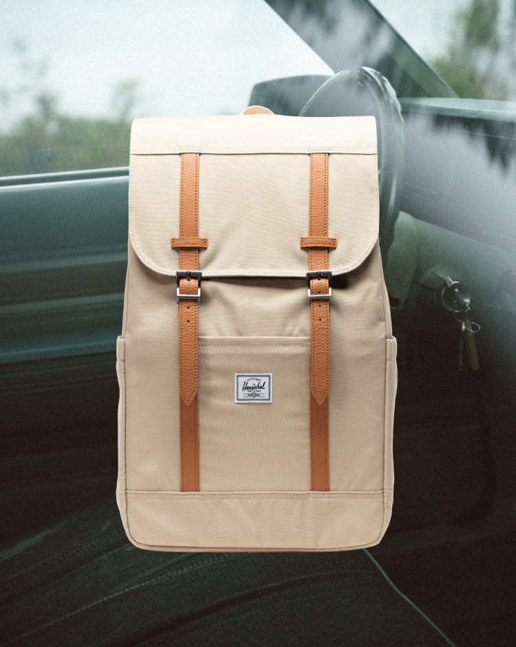 Herschel Retreat Backpack in light green Eucalyptus color, featuring a drawstring closure, front flap with strap, and woven logo label.