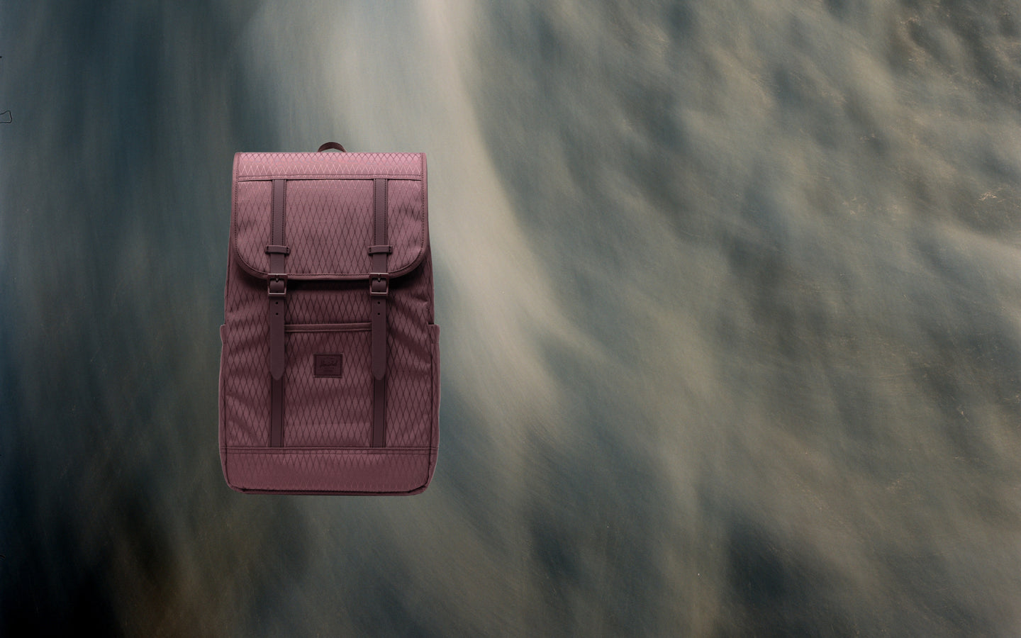 Herschel Retreat Backpack in Huckleberry Diamond pattern, featuring a top handle and adjustable shoulder straps.