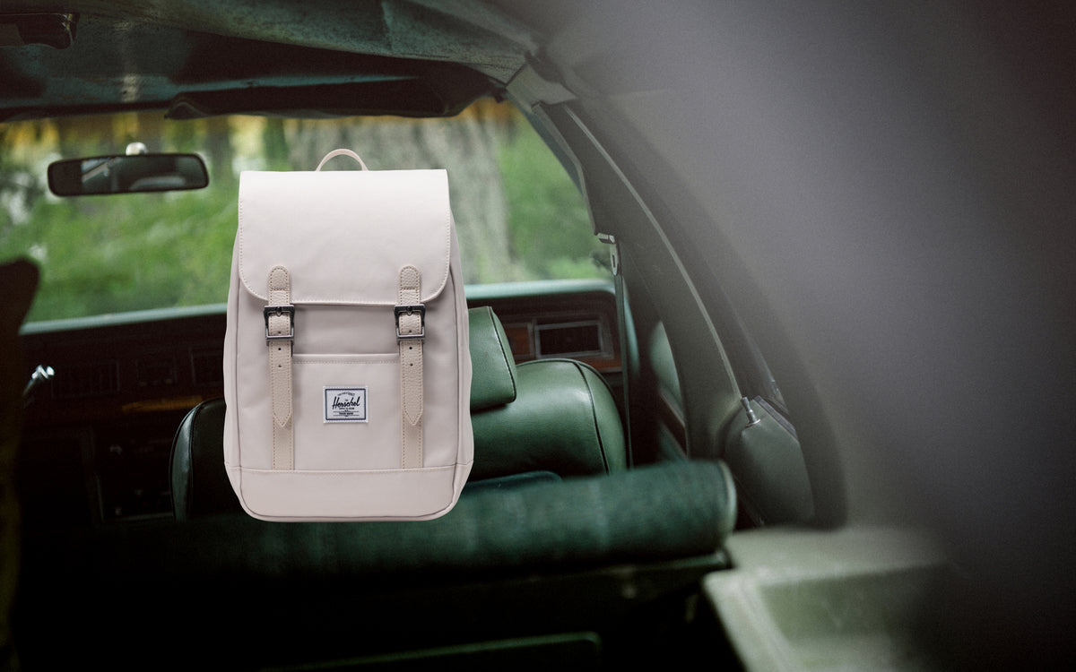 Herschel Retreat Mini Backpack in Moonbeam colorway, featuring a compact design with front storage sleeve and magnetic strap closures.