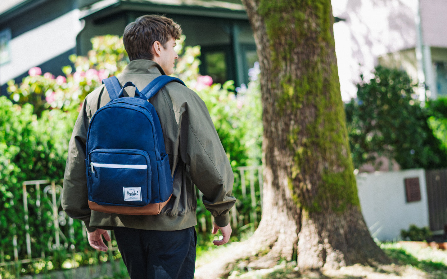 Herschel Supply Co. Pop Quiz Backpack in Navy/Tan shown from the front against a white background, highlighting its clean design and front pocket.