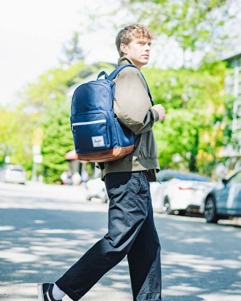Herschel Supply Co. Pop Quiz Backpack in Navy blue with a Tan synthetic leather bottom and front pocket accent.