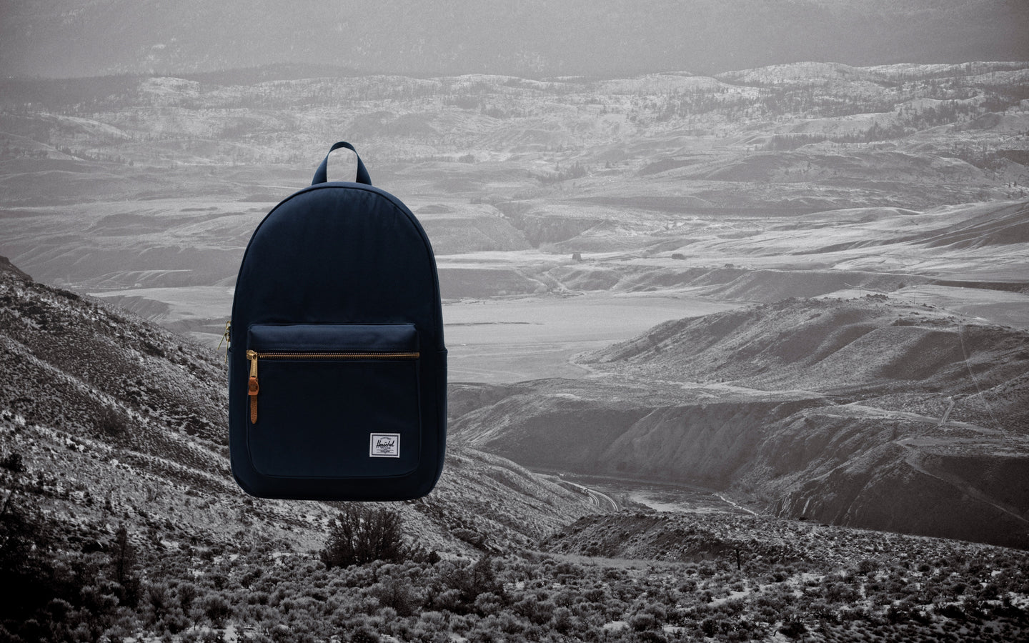 Herschel Supply Co. Settlement Backpack in navy blue, shown from the front on a clean background.