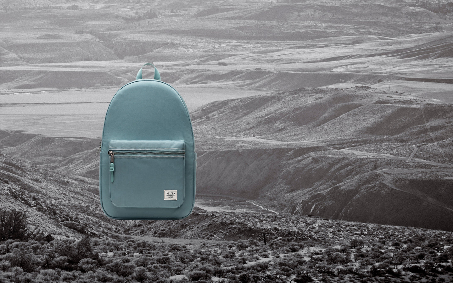 Herschel Supply Co. Settlement Backpack in a minimalist, classic design with a front zippered pocket and a top carry handle.