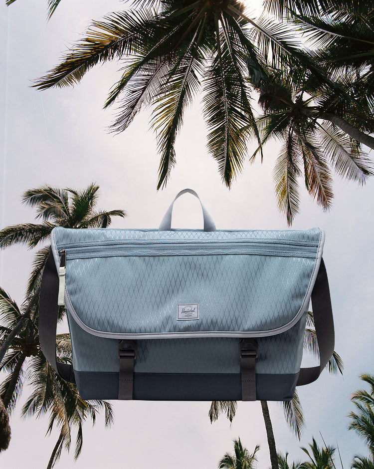 Herschel Supply Co. Cove Messenger bag in Blue Mirage Diamond/Sea Storm pattern, shown from the front.