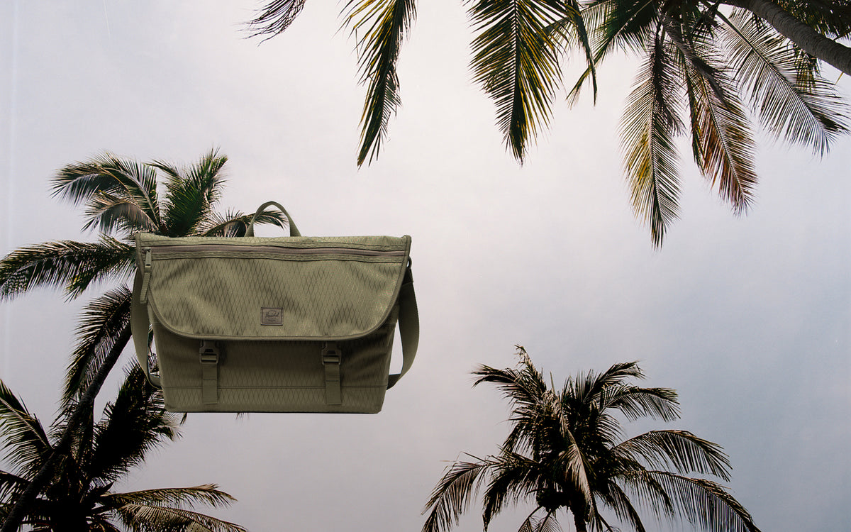 Herschel Supply Co. Cove Messenger bag in Ivy Green Diamond, shown from a desktop hero perspective.