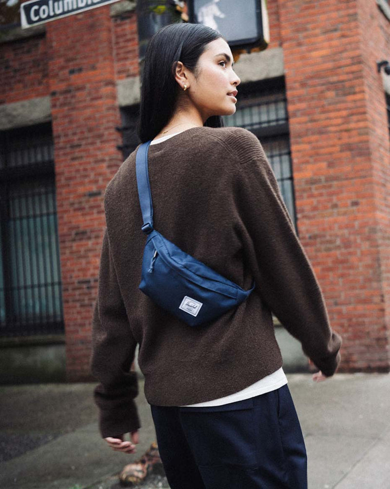 Herschel Supply Co. Classic Hip Pack in Navy blue, shown from the front to highlight its clean design and zippered main compartment.