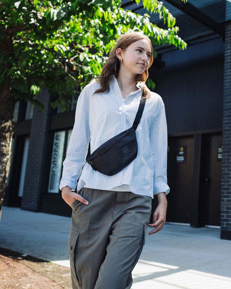 Herschel Classic Hip Pack in Black Tonal featuring a clean, compact design with a zippered main compartment and an adjustable strap.