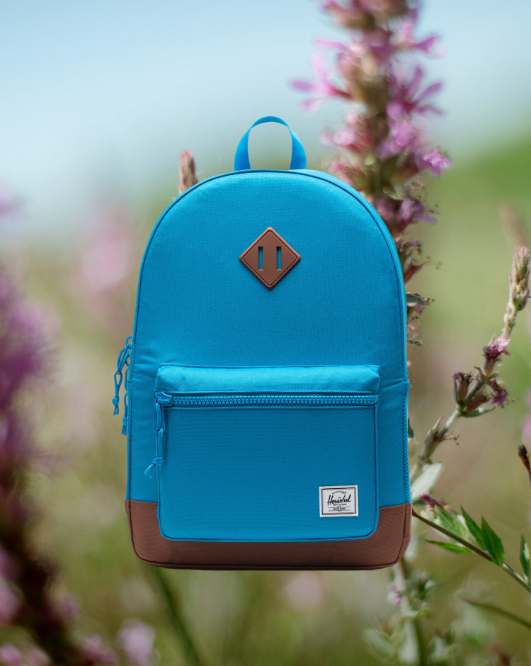 Herschel Heritage Youth Backpack in Hawaiian Surf blue with a Saddle Brown diamond accent and shoulder straps.