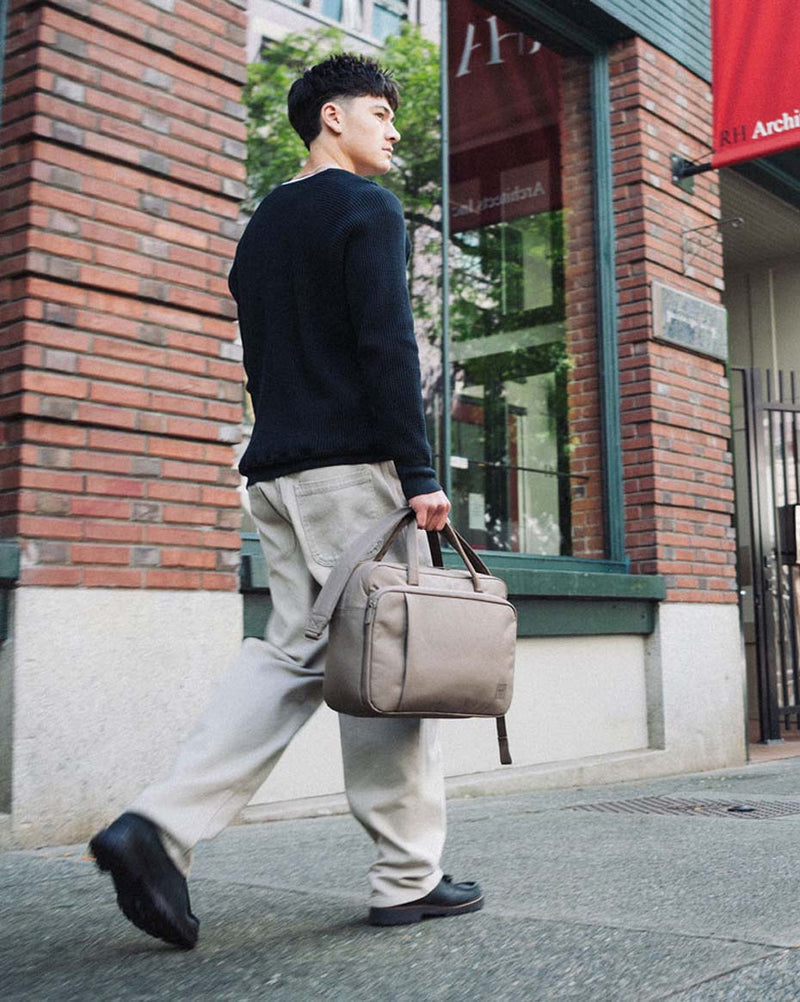 Herschel Supply Co. Gibson Messenger Tech bag in light brown, shown from a front angle.