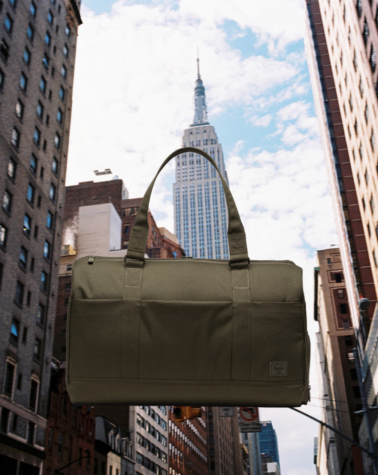 Herschel Novel Duffle Tech in Ivy Green Tonal, showing a front view of the bag.