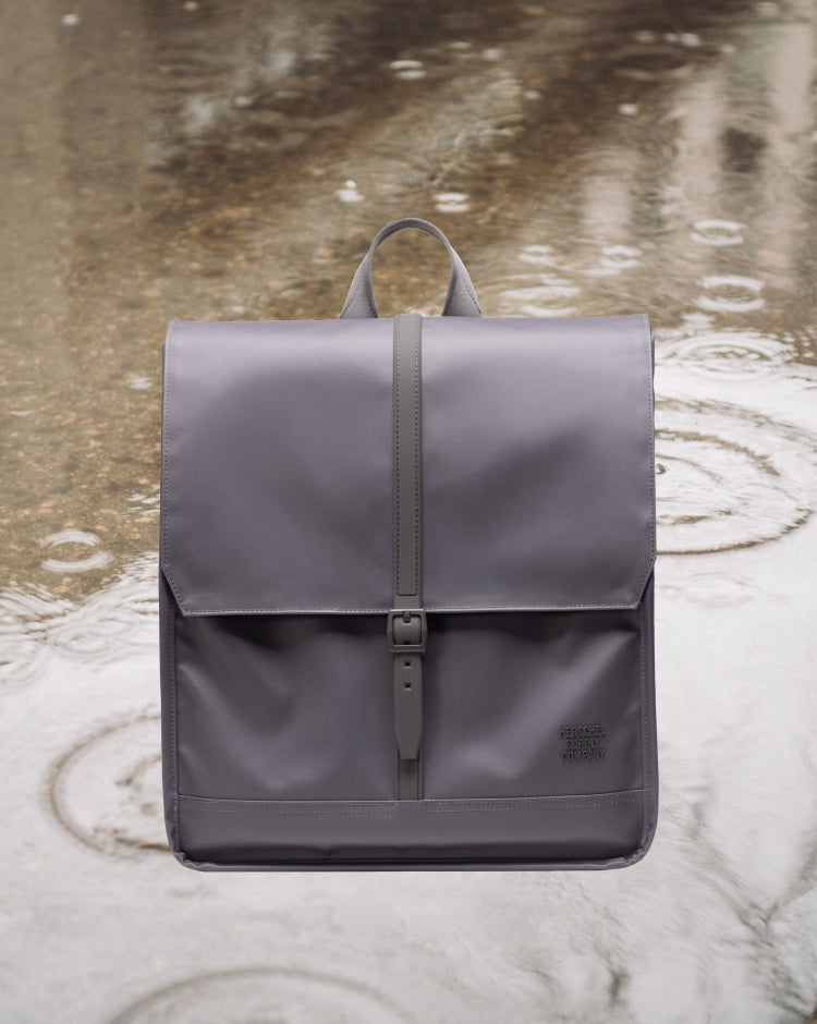 Herschel Supply Co. City Backpack in Dark Gull Gray, showing the clean, modern design and front strap detail.
