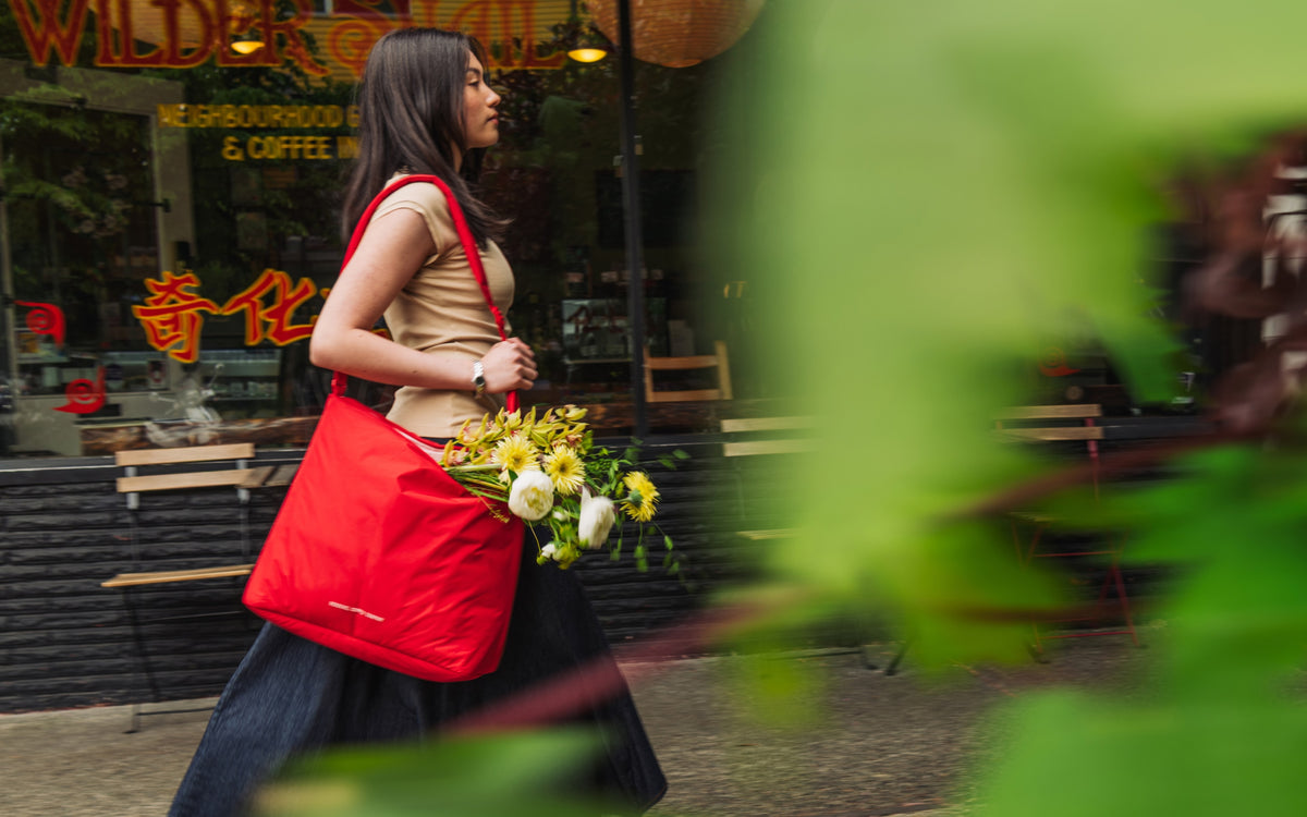 Herschel Supply Co. Cloudform Tote bag in Salsa red, shown from a front lifestyle view.