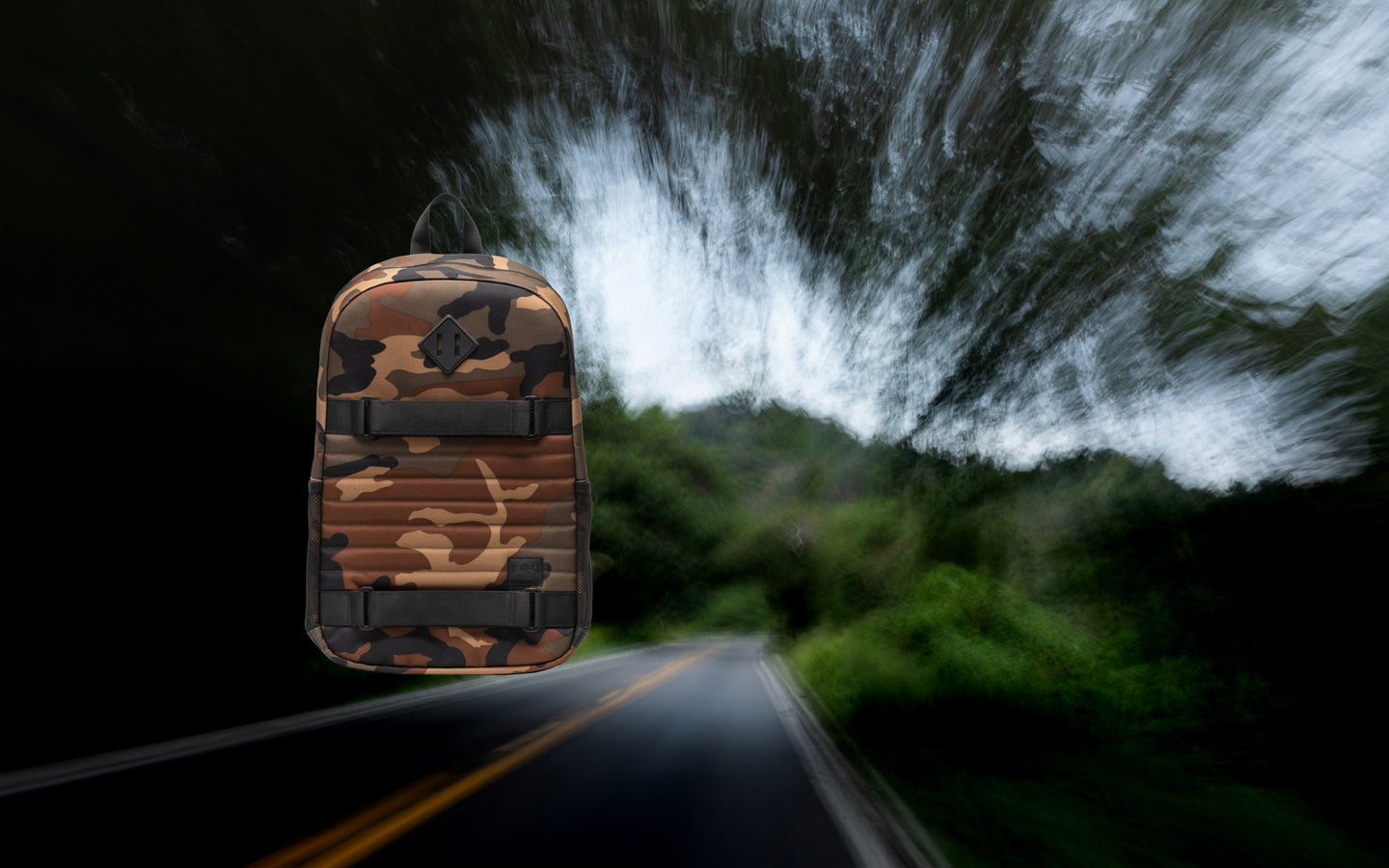 Herschel Supply Co Fleet Skate Backpack in Woodland Camo/Black shown from the front.