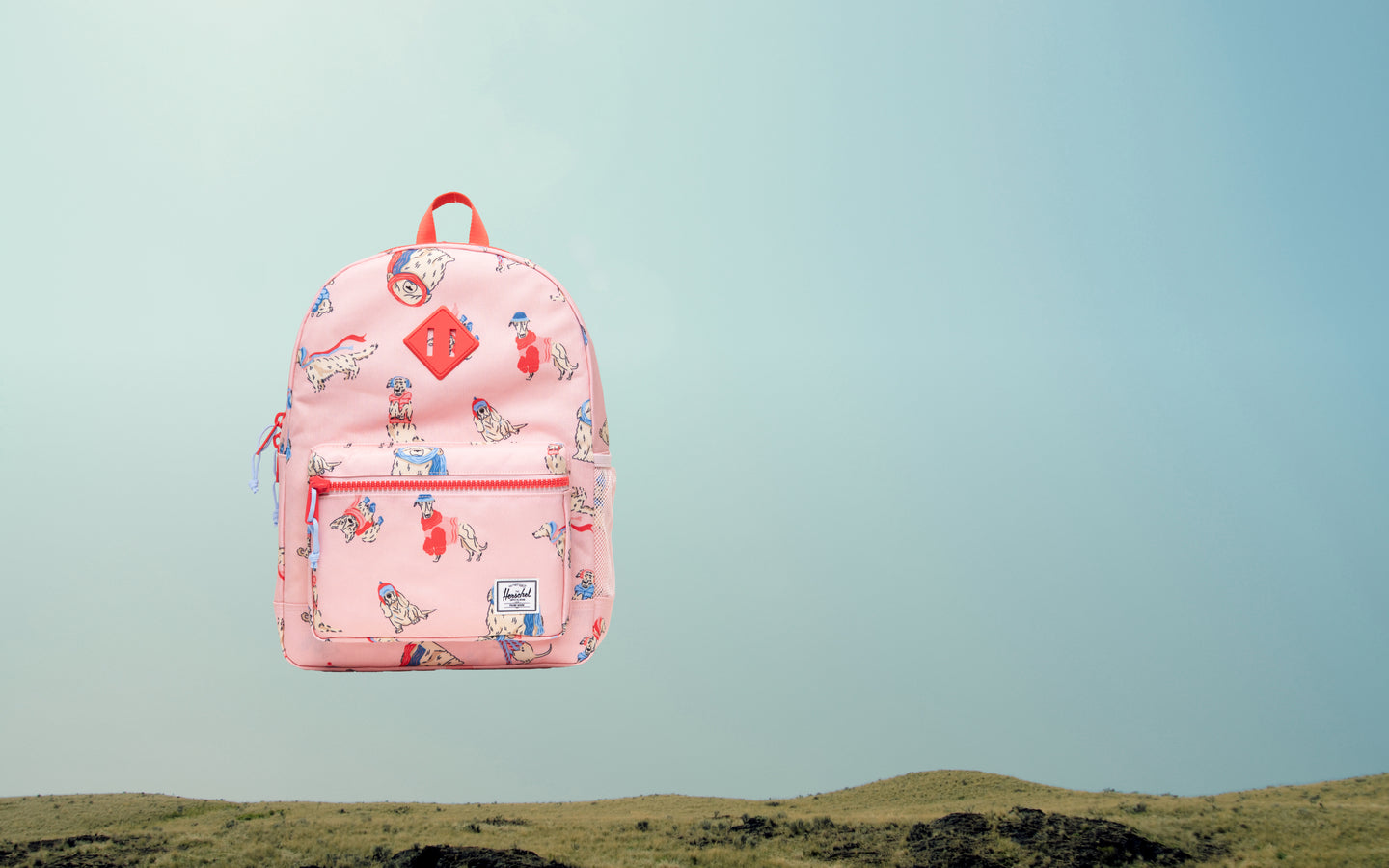 Herschel Heritage Kids Backpack in the Fashion Dogs pattern, featuring a colorful dog print design.
