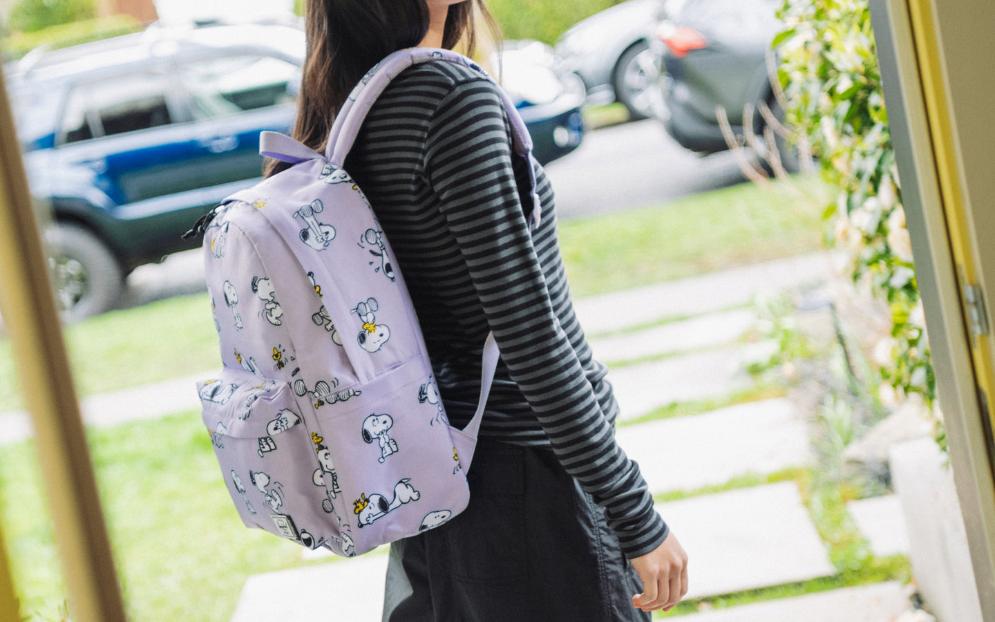 Herschel Supply Co. Peanuts Classic XL Backpack in Snoopy and Woodstock Pastel Lilac, shown as a lifestyle banner image.
