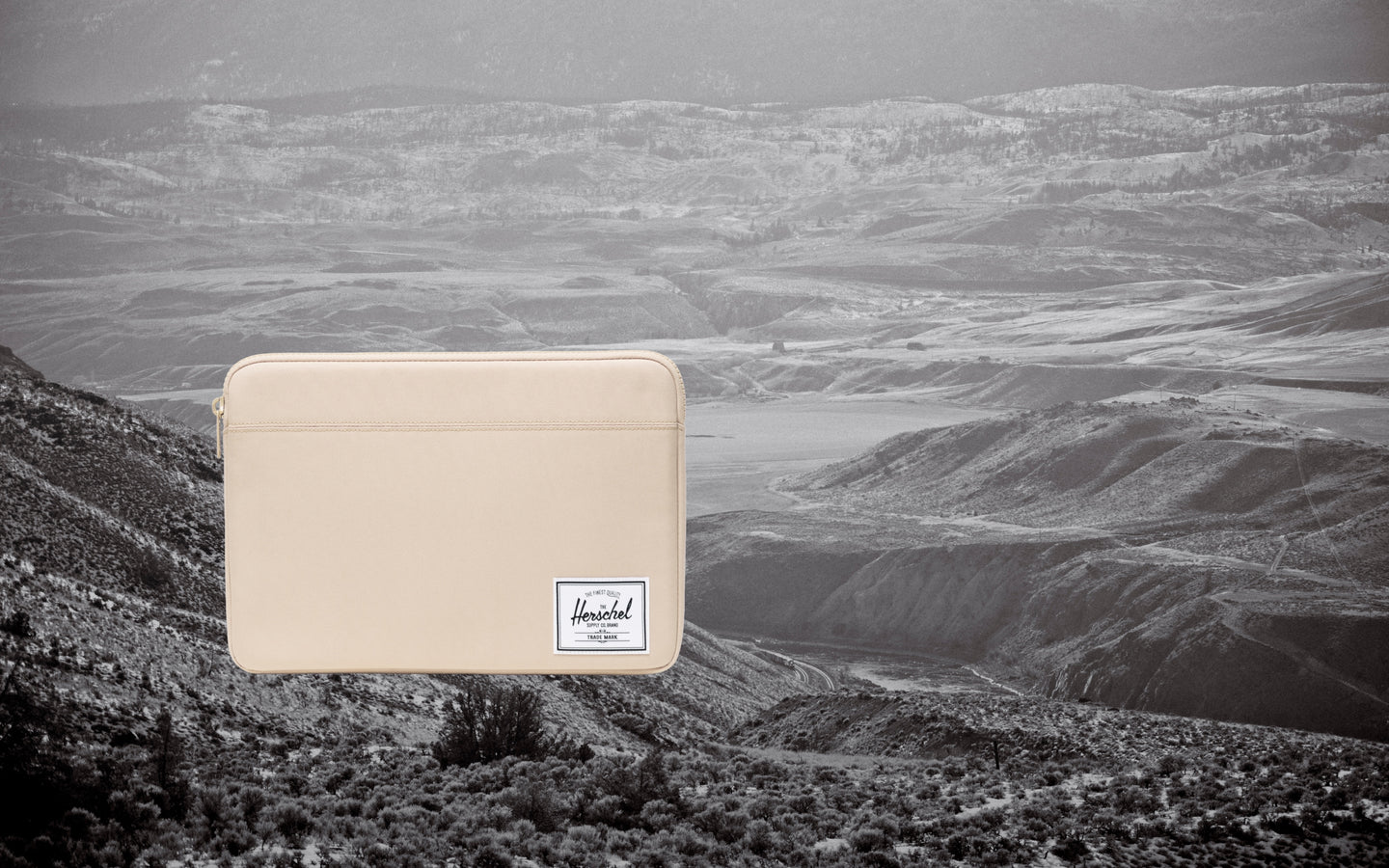 Herschel Supply Co. Anchor 14 Inch Sleeve in Eucalyptus green, shown from a flat lay desktop view.