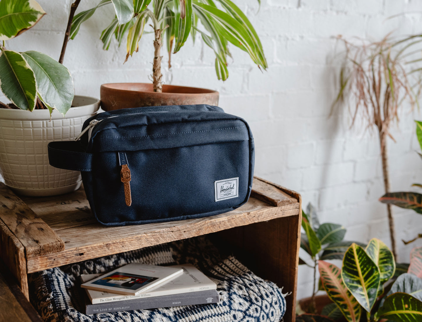 Herschel Supply Co. Chapter Travel Kit in solid navy blue featuring a convenient side carrying handle and classic woven logo label.
