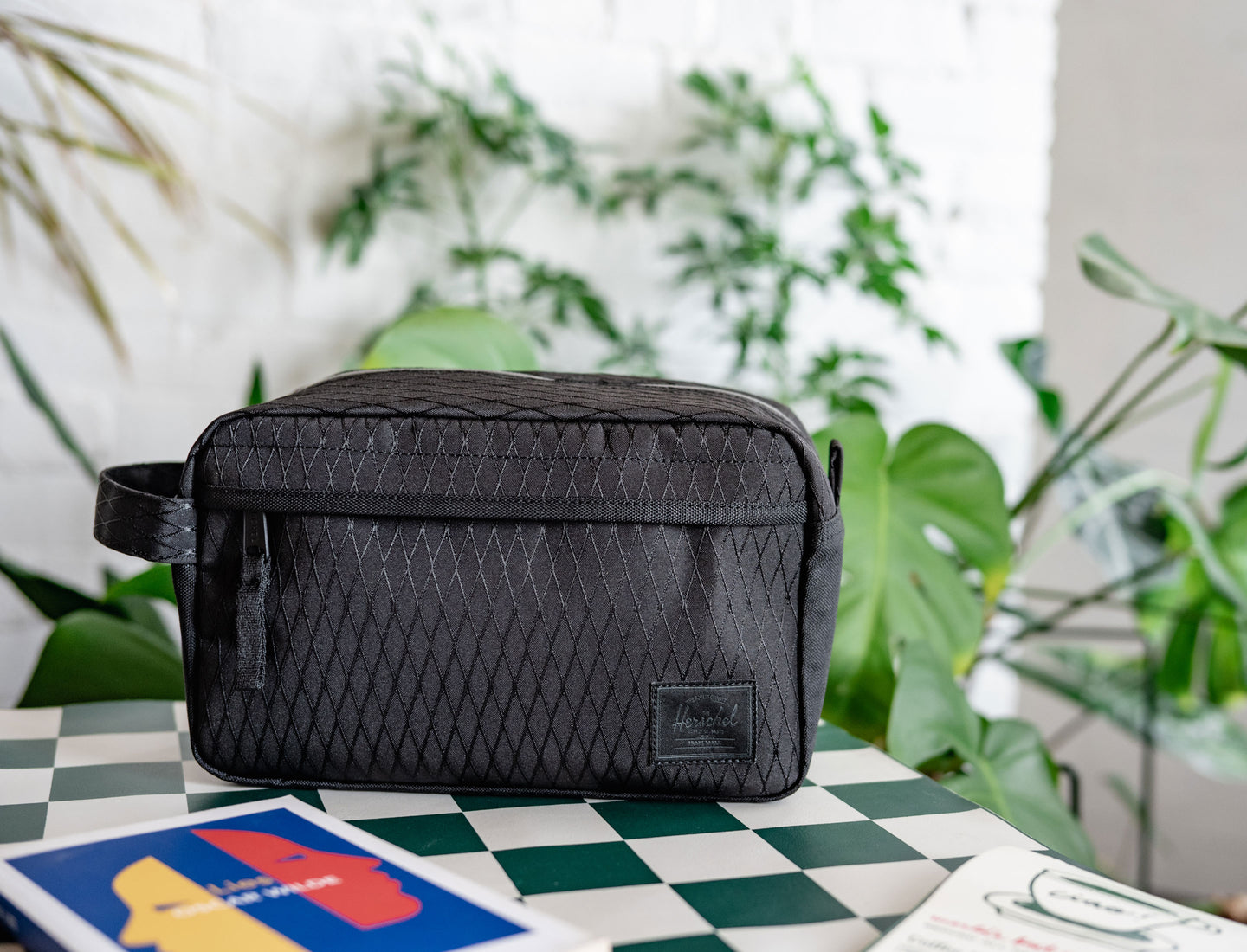 Herschel Supply Co. Chapter Travel Kit in Black Diamond/Black shown on a desktop banner layout.
