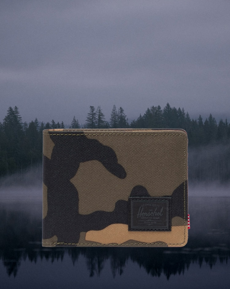 Herschel Supply Co. Roy Wallet in Woodland Camo with a classic bi-fold design, multiple card slots, and a black woven label.